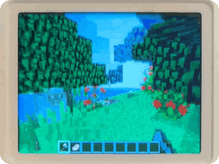 NumBlocks on a real NumWorks calculator, walking past trees and a sheep